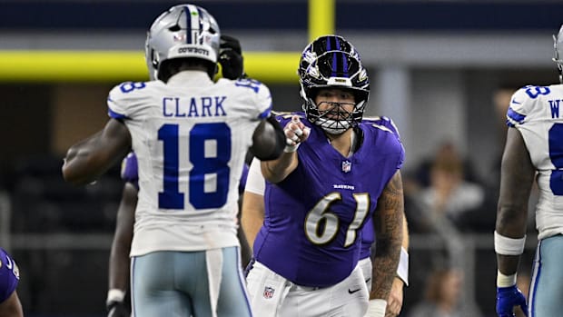 Baltimore Ravens center Nick Samac (61) points at Dallas Cowboys linebacker Damone Clark (18) during a preseason game.