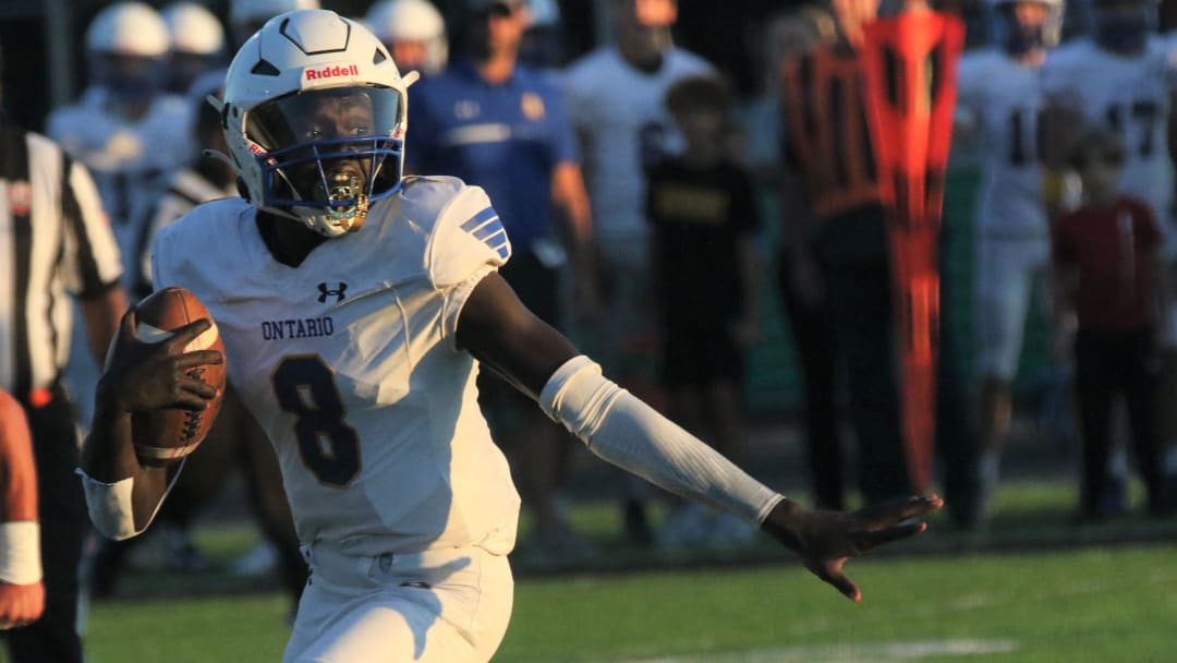 Ontario quarterback Bodpegn Miller guides his blockers during a long run that led to a 45-0 win over Clear Fork on Friday night.