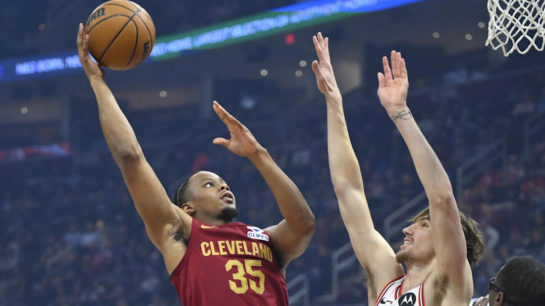 Apr 8, 2025; Cleveland, Ohio, USA; Cleveland Cavaliers forward Isaac Okoro (35) shoots beside Chicago Bulls forward Matas Buzelis (14) in the first quarter at Rocket Arena. Mandatory Credit: David Richard-Imagn Images