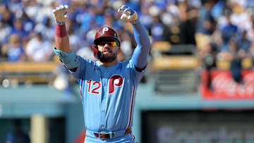 Oct 9, 2025; Los Angeles, California, USA; Philadelphia Phillies left fielder Kyle Schwarber (12) reacts after a double in the first inning against the Los Angeles Dodgers during game four of the NLDS round for the 2025 MLB playoffs at Dodger Stadium. Mandatory Credit: Jayne Kamin-Oncea-Imagn Images