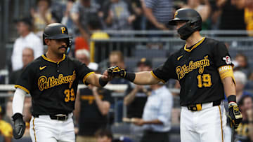 Jun 5, 2024; Pittsburgh, Pennsylvania, USA;  Pittsburgh Pirates shortstop Nick Gonzales (39) celebrates with second baseman Jared Triolo (19) after Gonzales scored a run against the Los Angeles Dodgers during the second inning at PNC Park. Mandatory Credit: Charles LeClaire-Imagn Images