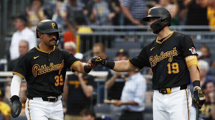 Jun 5, 2024; Pittsburgh, Pennsylvania, USA;  Pittsburgh Pirates shortstop Nick Gonzales (39) celebrates with second baseman Jared Triolo (19) after Gonzales scored a run against the Los Angeles Dodgers during the second inning at PNC Park. Mandatory Credit: Charles LeClaire-Imagn Images