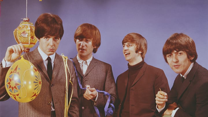 The Beatles pose for a birthday-themed picture