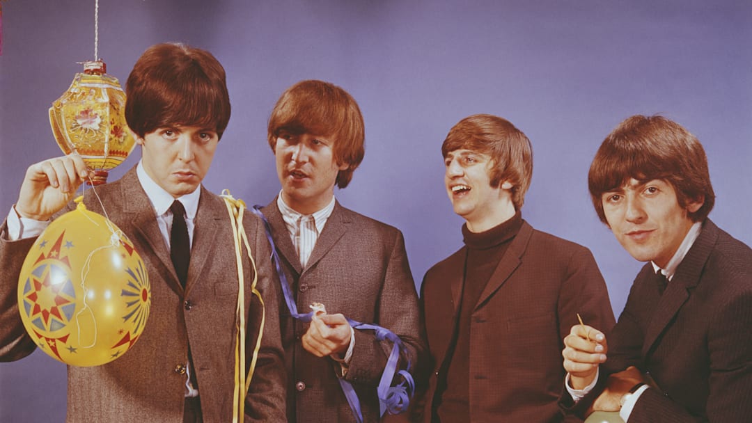 The Beatles holding a balloon