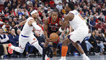 Oct 31, 2025; Chicago, Illinois, USA; Chicago Bulls guard Ayo Dosunmu (11) drives to the basket between New York Knicks forward OG Anunoby (8) and guard Josh Hart (3) during the first half at United Center. Mandatory Credit: Kamil Krzaczynski-Imagn Images