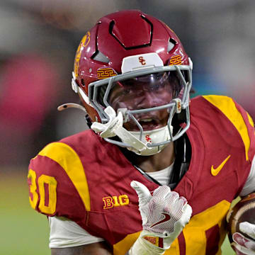 Oct 11, 2025; Los Angeles, California, USA; USC Trojans running back King Miller (30) runs for a touchdown in the second half against the Michigan Wolverines at United Airlines Field at the Los Angeles Memorial Coliseum. Mandatory Credit: Jayne Kamin-Oncea-Imagn Images