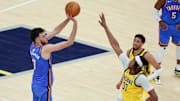 Oklahoma City Thunder forward Chet Holmgren shoots the ball defended by Indiana Pacers center Myles Turner and guard Tyrese Haliburton in the third quarter during game six of the 2025 NBA Finals at Gainbridge Fieldhouse. 