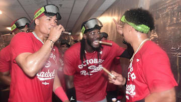 Sep 28, 2025; Milwaukee, Wisconsin, USA;  Cincinnati Reds shortstop Elly De La Cruz (center) celebrates after the Reds clinched a wild card spot after the game against the Milwaukee Brewers at American Family Field. Mandatory Credit: Benny Sieu-Imagn Images