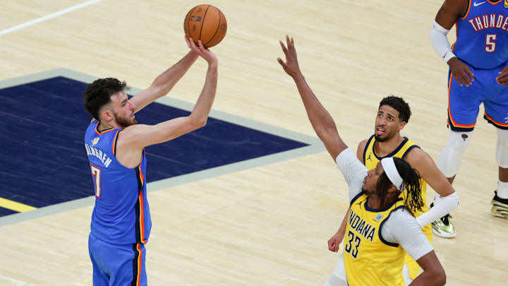 Oklahoma City Thunder forward Chet Holmgren shoots the ball defended by Indiana Pacers center Myles Turner and guard Tyrese Haliburton in the third quarter during game six of the 2025 NBA Finals at Gainbridge Fieldhouse. 