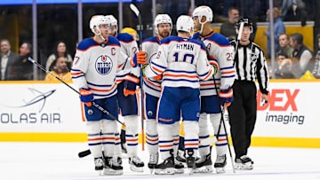 Oct 17, 2024; Nashville, Tennessee, USA;  Edmonton Oilers defenseman Brett Kulak (27) celebrates his goal with his teammates  against the Nashville Predators during the third period at Bridgestone Arena. Mandatory Credit: Steve Roberts-Imagn Images