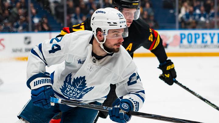 Jan 31, 2026; Vancouver, British Columbia, CAN; Vancouver Canucks defenseman Tyler Myers (57) defends against Toronto Maple Leafs forward Scott Laughton (24) in the third period at Rogers Arena. Mandatory Credit: Bob Frid-Imagn Images