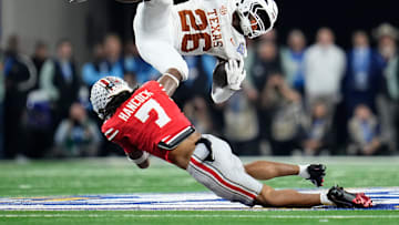 Ohio State Buckeyes cornerback Jordan Hancock (7) tackles Texas Longhorns running back Quintrevion Wisner (26) during the second half of the Cotton Bowl Classic College Football Playoff semifinal game