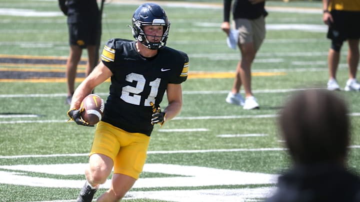 Iowa’s Kaden Wetjen (21) runs with the ball during Kids Day at Kinnick Saturday, Aug. 10, 2024 at Kinnick Stadium in Iowa City, Iowa.