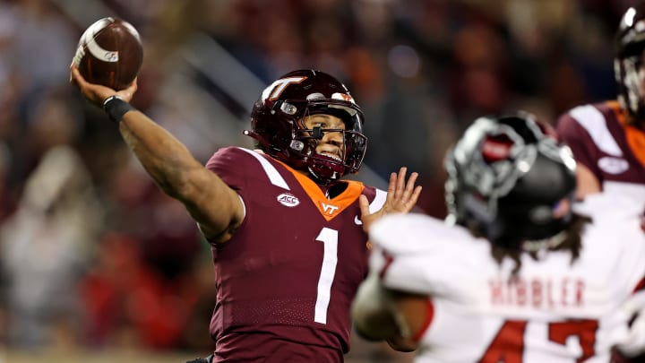 Nov 18, 2023; Blacksburg, Virginia, USA; Virginia Tech Hokies quarterback Kyron Drones (1) throws a pass against the North Carolina State Wolfpack at Lane Stadium. Mandatory Credit: Peter Casey-USA TODAY Sports