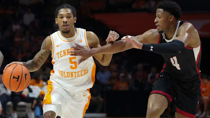 Tennessee's Zakai Zeigler (5) moves the ball while guarded by Austin Peay's LJ Thomas (4) during an NCAA college basketball game on Sunday, Nov. 17, 2024, in Knoxville, Tenn.