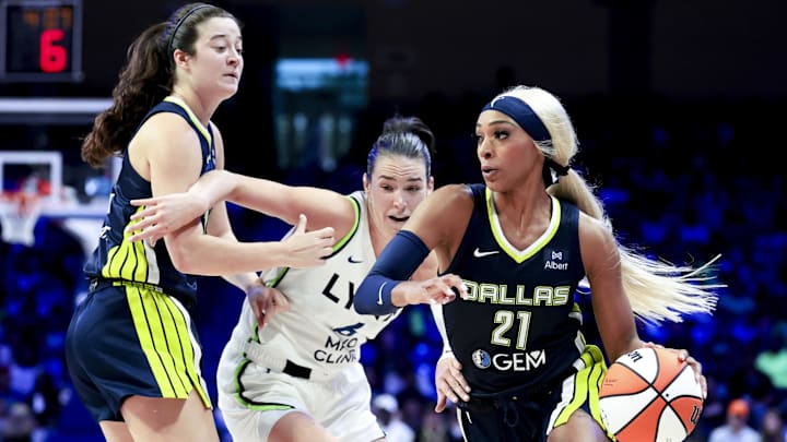 May 16, 2025; Arlington, Texas, USA;  Dallas Wings guard DiJonai Carrington (21) drives to the basket past Minnesota Lynx forward Bridget Carleton (6) during the second half at College Park Center. Mandatory Credit: Kevin Jairaj-Imagn Images