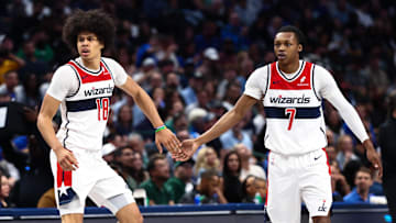 Oct 24, 2025; Dallas, Texas, USA;  Washington Wizards forward Kyshawn George (18) celebrates with Washington Wizards guard Bub Carrington (7) during the second half against the Dallas Mavericks at American Airlines Center. Mandatory Credit: Kevin Jairaj-Imagn Images