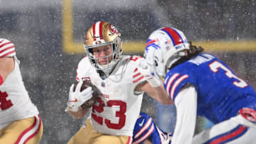 Dec 1, 2024; Orchard Park, New York, USA; San Francisco 49ers running back Christian McCaffrey (23) tries to avoid Buffalo Bills safety Damar Hamlin (3) on a run in the first quarter at Highmark Stadium. Mandatory Credit: Mark Konezny-Imagn Images