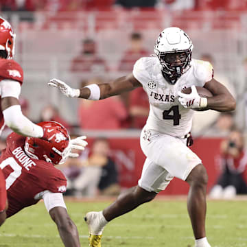 Oct 18, 2025; Fayetteville, Arkansas, USA; Texas A&M Aggies running back Rueben Owens II (4) rushes during the fourth quarter against the Arkansas Razorbacks at Donald W. Reynolds Razorback Stadium. Mandatory Credit: Nelson Chenault-Imagn Images