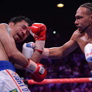 Manny Pacquiao (white trunks) and Keith Thurman (red/white/blue trunks) box during their WBA welterweight championship bout at MGM Grand Garden Arena. Pacquiao won via split decision. 