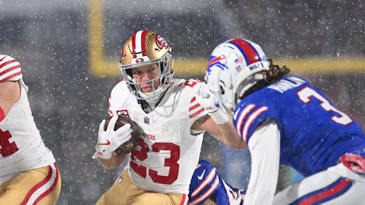 Dec 1, 2024; Orchard Park, New York, USA; San Francisco 49ers running back Christian McCaffrey (23) tries to avoid Buffalo Bills safety Damar Hamlin (3) on a run in the first quarter at Highmark Stadium. Mandatory Credit: Mark Konezny-Imagn Images
