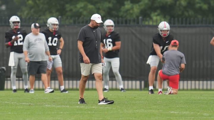 Aug 2, 2024; Columbus, Ohio, USA; Ohio State Buckeyes head coach Ryan Day looks down while evaluating the quarterbacks during Fall Camp practice Aug. 2, 2024 at the Woody Hayes Athletic Center.