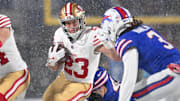 Dec 1, 2024; Orchard Park, New York, USA; San Francisco 49ers running back Christian McCaffrey (23) tries to avoid Buffalo Bills safety Damar Hamlin (3) on a run in the first quarter at Highmark Stadium. Mandatory Credit: Mark Konezny-Imagn Images