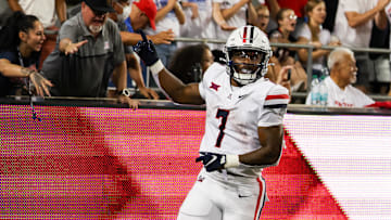 Aug 31, 2024; Tucson, Arizona, USA; Arizona Wildcats running back Quali Conley (7) celebrates touchdown with Arizona Wildcat fans during fourth quarter at Arizona Stadium. 