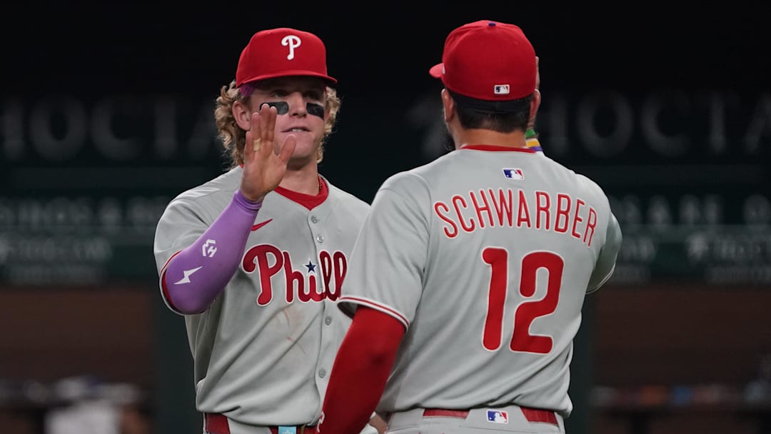 Aug 9, 2025; Arlington, Texas, USA; Philadelphia Phillies outfielder Harrison Bader (2) high fives outfielder Kyle Schwarber (12) following a game against the Texas Rangers at Globe Life Field. Mandatory Credit: Raymond Carlin III-Imagn Images