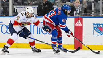 May 30, 2024; New York, New York, USA; New York Rangers center Mika Zibanejad (93) passes the puck as New York Rangers center Vincent Trocheck (16) defends during the third period in game five of the Eastern Conference Final of the 2024 Stanley Cup Playoffs at Madison Square Garden. Mandatory Credit: Dennis Schneidler-USA TODAY Sports