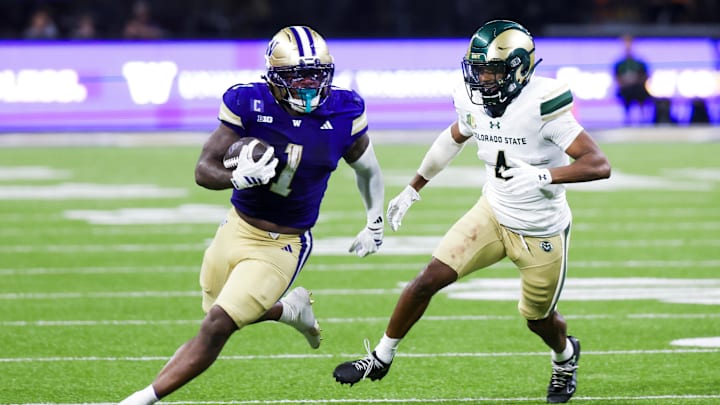 Aug 30, 2025; Seattle, Washington, USA; Washington Huskies running back Jonah Coleman (1) rushes against Colorado State Rams defensive back Jahari Rogers (4) during the fourth quarter at Husky Stadium. Mandatory Credit: Joe Nicholson-Imagn Images