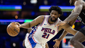 Feb 22, 2025; Philadelphia, Pennsylvania, USA; Philadelphia 76ers center Joel Embiid (21) controls the ball against Brooklyn Nets center Day'Ron Sharpe (20) during the third quarter at Wells Fargo Center. Mandatory Credit: Bill Streicher-Imagn Images