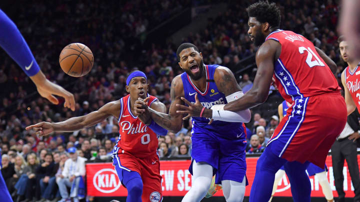 Feb 11, 2020; Philadelphia, Pennsylvania, USA; LA Clippers guard Paul George (13) is fouled by Philadelphia 76ers center Joel Embiid (21) during the first quarter at Wells Fargo Center. Mandatory Credit: Eric Hartline-USA TODAY Sports