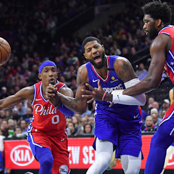 Feb 11, 2020; Philadelphia, Pennsylvania, USA; LA Clippers guard Paul George (13) is fouled by Philadelphia 76ers center Joel Embiid (21) during the first quarter at Wells Fargo Center. Mandatory Credit: Eric Hartline-Imagn Images