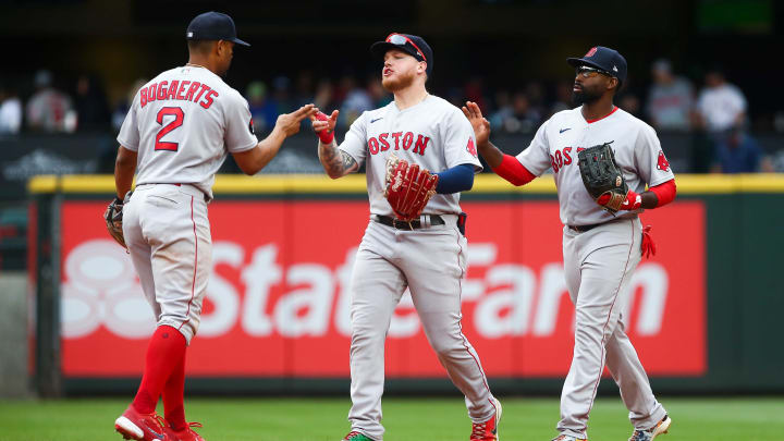 Jun 12, 2022; Seattle, Washington, USA;  Boston Red Sox shortstop Xander Bogaerts (2) celebrates a 2-0 win over the Seattle Mariners with left fielder Alex Verdugo (99) and center fielder Jackie Bradley Jr. (19) at T-Mobile Park. Mandatory Credit: Lindsey Wasson-USA TODAY Sports