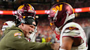 Oct 27, 2025; Kansas City, Missouri, USA; Washington Commanders head coach Dan Quinn celebrates an interception against the Kansas City Chiefs with Washington Commanders cornerback Marshon Lattimore (2) during the first quarter of the game at GEHA Field at Arrowhead Stadium. Mandatory Credit: Jay Biggerstaff-Imagn Images
