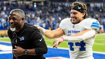 Detroit Lions defensive coordinator Aaron Glenn and linebacker Malcolm Rodriguez (44) celebrate 24-6 win over Indianapolis Colts as they exit the field at Lucas Oil Stadium in Indianapolis, Ind. on Sunday, Nov. 24, 2024.