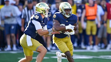 Sep 7, 2024; South Bend, Indiana, USA; Notre Dame Fighting Irish quarterback Riley Leonard (13) hands off to running back Jadarian Price (24) in the third quarter against the Northern Illinois Huskies at Notre Dame Stadium. Mandatory Credit: Matt Cashore-Imagn Images