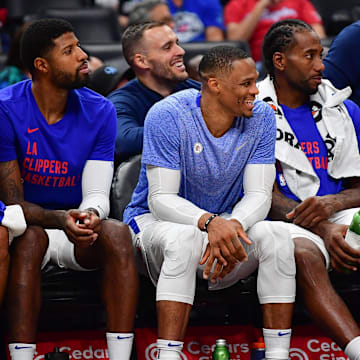 Oct 29, 2023; Los Angeles, California, USA; Los Angeles Clippers forward Nicolas Batum (33) forward Paul George (13) guard Russell Westbrook (0) and forward Kawhi Leonard (2) watch game action aganst the San Antonio Spurs during the second half at Crypto.com Arena. Mandatory Credit: Gary A. Vasquez-Imagn Images