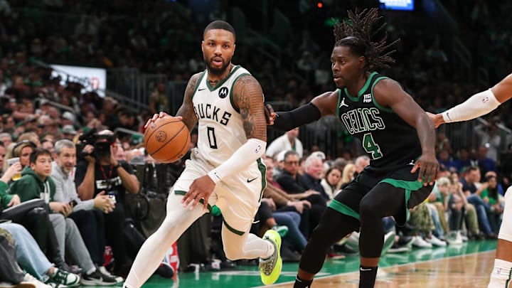 Nov 22, 2023; Boston, Massachusetts, USA; Milwaukee Bucks guard Damian Lillard (0) drives to the basket defended by Boston Celtics guard Jrue Holiday (4) during the second half at TD Garden. Mandatory Credit: Paul Rutherford-Imagn Images