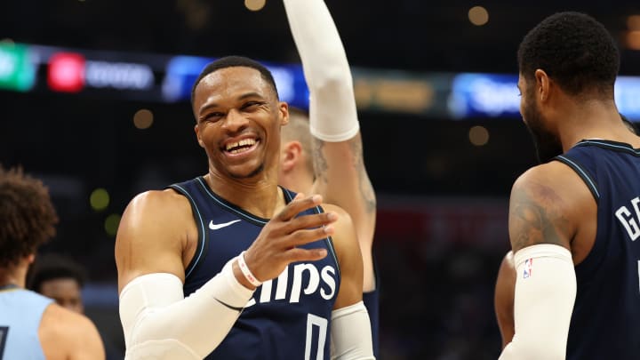 Dec 29, 2023; Los Angeles, California, USA;  Los Angeles Clippers guard Russell Westbrook (0) smiles after forward Paul George (13) makes a three point basket during the third quarter against the Memphis Grizzlies at Crypto.com Arena. Mandatory Credit: Kiyoshi Mio-Imagn Images