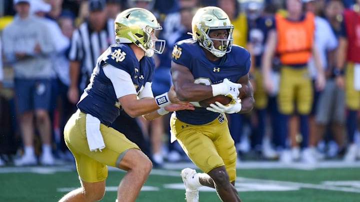 Sep 7, 2024; South Bend, Indiana, USA; Notre Dame Fighting Irish quarterback Riley Leonard (13) hands off to running back Jadarian Price (24) in the third quarter against the Northern Illinois Huskies at Notre Dame Stadium. Mandatory Credit: Matt Cashore-Imagn Images