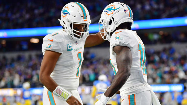 Dec 11, 2022; Inglewood, California, USA; Miami Dolphins wide receiver Tyreek Hill (10) celebrates his touchdown scored against the Los Angeles Chargers with quarterback Tua Tagovailoa (1) during the first half at SoFi Stadium. Mandatory Credit: Gary A. Vasquez-USA TODAY Sports