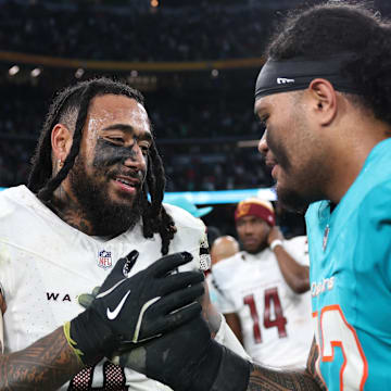 Washington Commanders linebacker Frankie Luvu (4) shakes hands with Miami Dolphins player Jonah Savaiinaea after the 2025 NFL Madrid Game at Santiago Bernabeu Stadium. 