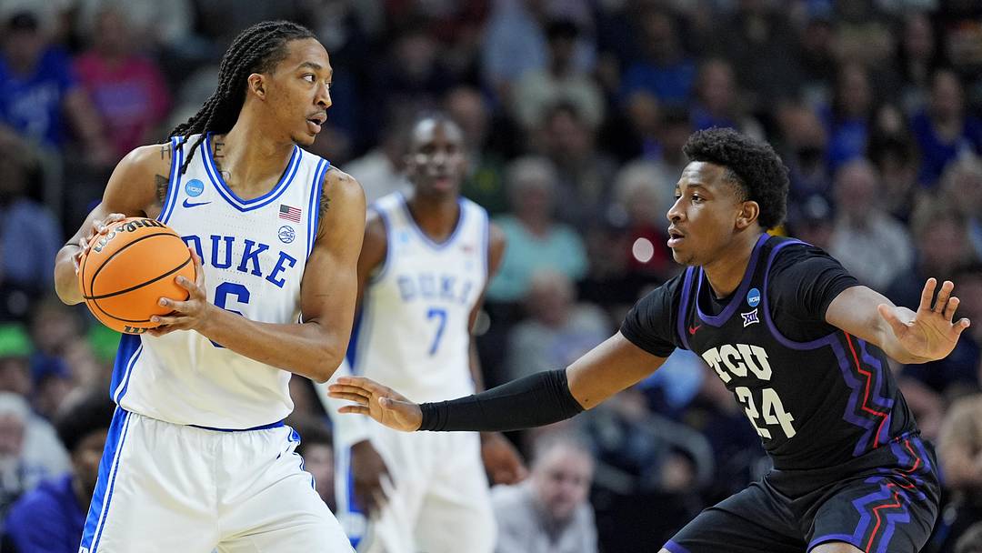 Mar 21, 2026; Greenville, SC, USA; Duke Blue Devils forward Maliq Brown (6) controls the ball as Texas Christian University Horned Frogs forward Xavier Edmonds (24) defends during the first half during a second round game of the men's 2026 NCAA Tournament at Bon Secours Wellness Arena. Mandatory Credit: Jim Dedmon-Imagn Images