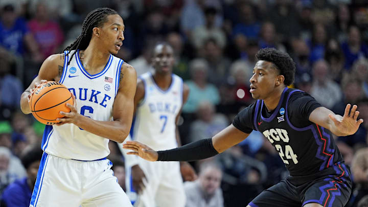 Mar 21, 2026; Greenville, SC, USA; Duke Blue Devils forward Maliq Brown (6) controls the ball as Texas Christian University Horned Frogs forward Xavier Edmonds (24) defends during the first half during a second round game of the men's 2026 NCAA Tournament at Bon Secours Wellness Arena. Mandatory Credit: Jim Dedmon-Imagn Images