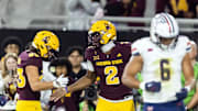 Nov 28, 2025; Tempe, Arizona, USA; Arizona State Sun Devils quarterback Jeff Sims (2) celebrates with wide receiver Derek Eusebio (83) after running for a touchdown against the Arizona Wildcats in the first half during the 99th Territorial Cup at Mountain America Stadium. Mandatory Credit: Mark J. Rebilas-Imagn Images
