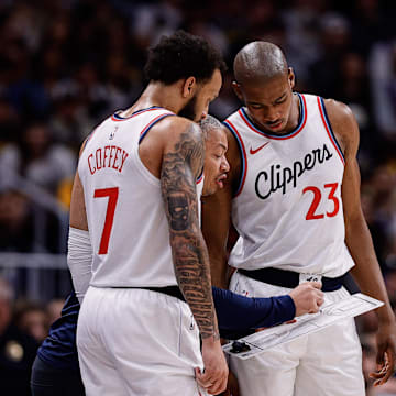 Oct 26, 2024; Denver, Colorado, USA; Los Angeles Clippers head coach Tyronn Lue talks with guard Amir Coffey (7) and forward Kai Jones (23) in the second quarter against the Denver Nuggets at Ball Arena. Mandatory Credit: Isaiah J. Downing-Imagn Images