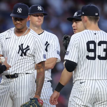  New York Yankees starting pitcher Luis Gil (81) hands the ball to manager Aaron Boone (17) after being taken out of the game against the Cincinnati Reds during the fifth inning at Yankee Stadium on July 2.