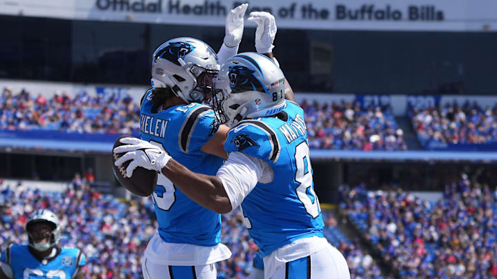 Aug 24, 2024; Orchard Park, New York, USA; Carolina Panthers wide receiver Adam Thielen (19) celebrates with  Carolina Panthers tight end Jordan Matthews (81) for scoring a touchdown against the Buffalo Bills during the first half at Highmark Stadium.